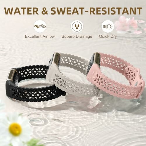 Three perforated watch bands in black, white, and pink displayed on water surface.