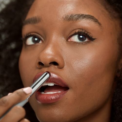 Woman applying lipstick